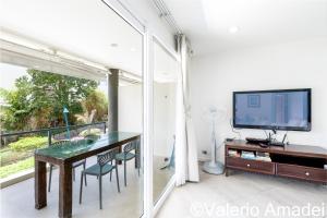 a dining room with a table and a tv at KB Apartments Karon Beach by PHR in Karon Beach