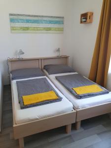 Postel nebo postele na pokoji v ubytování Főnix Üdülőház Zamárdi