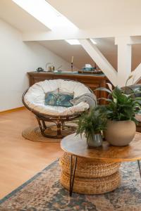 a living room with a chair and a table at La Casa Bonita in Bad Aibling