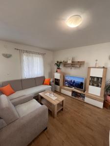 a living room with a couch and a flat screen tv at Lavanda Apartment in Stari Grad