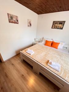 a bedroom with a large bed with orange pillows at Lavanda Apartment in Stari Grad