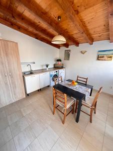 a kitchen and dining room with a table and chairs at Lavanda Apartment in Stari Grad