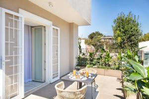 a patio with a table and chairs on a balcony at Dama Pompei - Luxury Apartment in Pompei