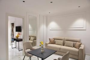 a living room with a couch and a table at Dama Pompei - Luxury Apartment in Pompei