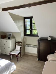 a bedroom with a bed and a chair and a window at Mountain View in Arcizans-Avant