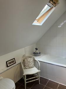 a white room with a chair and a skylight at Mountain View in Arcizans-Avant +31 photos