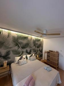 a bedroom with two beds with a tropical wallpaper at Paraíso en Fuerteventura in Costa Calma