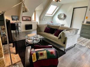 a living room with a couch and a table at Appart'hotel Maison Saint Michel in Paimpol