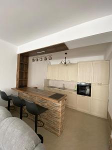 a kitchen with a counter and some chairs in a room at Jardin in Igalo