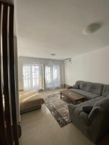 a living room with a couch and a table at Jardin in Igalo