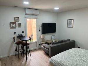a living room with a couch and a table at Studio LOUNA in Vesoul