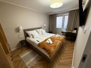 a bedroom with a bed with two towels on it at uDany w Goniądzu in Goniadz