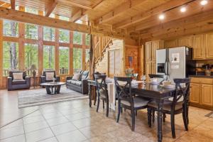 a kitchen and living room with a table and chairs at Dog Friendly, Hot Tub, Game Room, Ev Charger in Gatlinburg