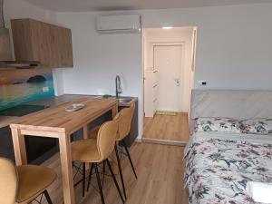 a small room with a bed and a table and chairs at CoCo Apartment in Ljubljana