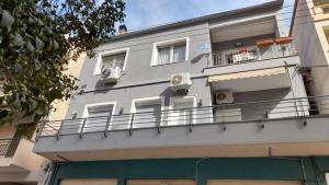 an apartment building with a balcony and air conditioners at Twin Stars in Drama