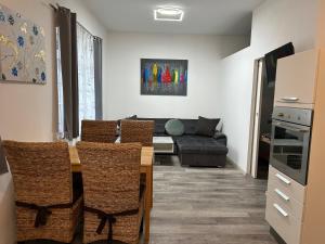 a living room with a table and chairs and a couch at Appartement Radwerk 14 in Vordernberg
