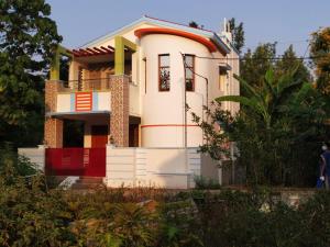 a white house with a red fence in front of it at The Last Villa in Yercaud