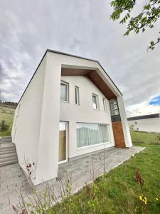 a white house with a large window at Villa Poljine Hills A80 in Sarajevo