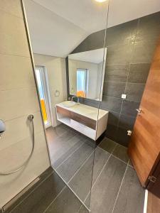 a bathroom with a shower and a sink and a mirror at Villa Poljine Hills A80 in Sarajevo +15 photos