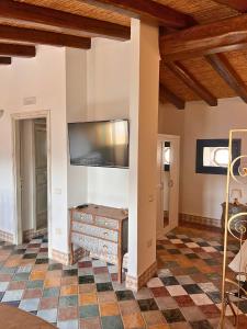 a living room with a tv on a wall at Ogliastra Luxury Apartment - AJPSARDINIA in Tortolì