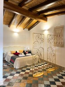 a bedroom with a bed and a checkered floor at Ogliastra Luxury Apartment - AJPSARDINIA in Tortolì