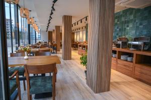 a restaurant with a table and chairs in a room at Landmark Hotel in Batumi