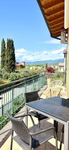 a patio with a table and chairs on a balcony at La Casetta Lazise in Lazise +46 photos