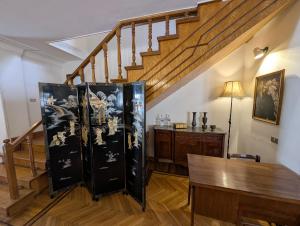 a living room with a staircase and a wooden table at Villa Maadi 35 -R 3 - Poolside Master Room in Cairo