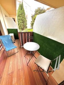 two chairs and a table on a balcony at Studio La Baronne in Cannes