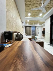 a large wooden table in a living room at Royal Holiday Homes in Zirakpur