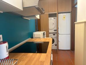 a kitchen with a refrigerator and a washer and dryer at Casa Aliya in Bassano del Grappa +11 photos