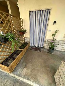 a patio with plants and a window with a curtain at Entire Apartment FabryExperience in Mozzanica