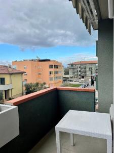 a white table on a balcony with a view at Casa vacanze a Porto Recanati in Porto Recanati