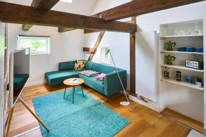 a living room with a green couch and a blue rug at Urlauberei Malchow in Malchow