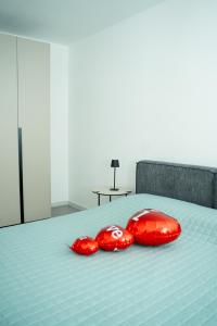 two red computer mice sitting on a bed at Diamond luxury house in Monopoli