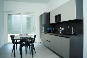 a kitchen with a table and chairs and a sink at Diamond luxury house in Monopoli
