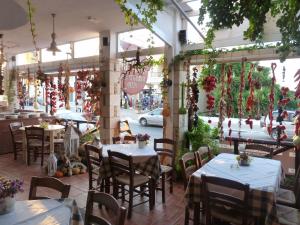 a restaurant with tables and chairs and a street at Mithos Apartments in Agia Marina Nea Kydonias