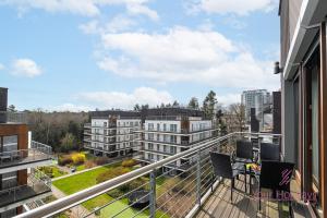 a balcony with chairs and a view of a building at Your Holidays Golden Tulip in Międzyzdroje