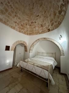 a bedroom with a bed with a stone ceiling at I Trulli di Mimì in Monopoli