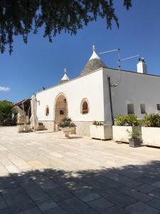 a white church with a large building at I Trulli di Mimì in Monopoli