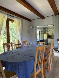 a dining room with a blue table and chairs at Bosio nad morze in Sztutowo