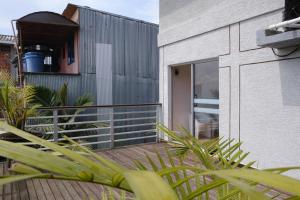 a balcony of a house with plants in the foreground at Three House Hostel Boutique in Filandia