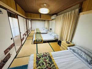 Postel nebo postele na pokoji v ubytování Shiga Biwa Lake Shanshui House