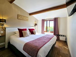 a bedroom with a large bed with red pillows at Domaine de La Rhonie in Meyrals +55 photos