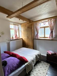 a bedroom with a bed and two windows at Stadtvilla Jelena Mengen in Mengen