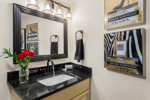a bathroom with a sink and a mirror at Walk to Anakeesta Romantic 1BR w Fireplace in Gatlinburg