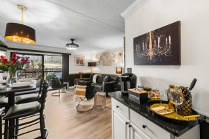 a kitchen and living room with a table and chairs at Walk to Anakeesta Romantic 1BR w Fireplace in Gatlinburg