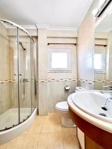 a bathroom with a sink and a toilet and a shower at Vistas al mar, El Puig in El Puig