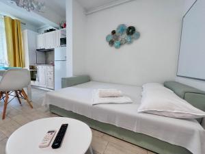 a bedroom with a bed and a table with a remote control at Alezzi Beach Resort - Sea View Suite in Mamaia Nord +95 photos