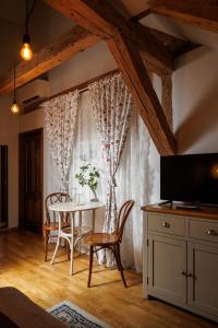 a dining room with a table and chairs and a window at Wood House Republicii in Braşov